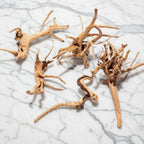 Driftwood pieces on a marble surface