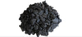 Heap of black coal on a marble surface