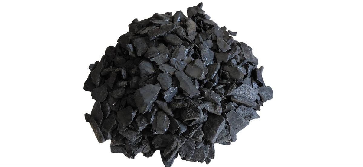Heap of black coal on a marble surface