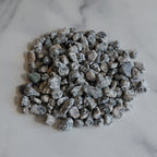 Small pile of gray stones on a marble surface