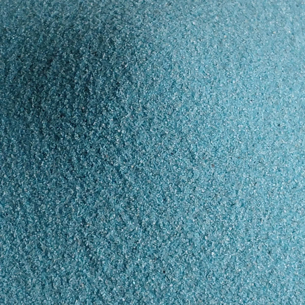 Close-up blue sand- for terrariums on a marble surface