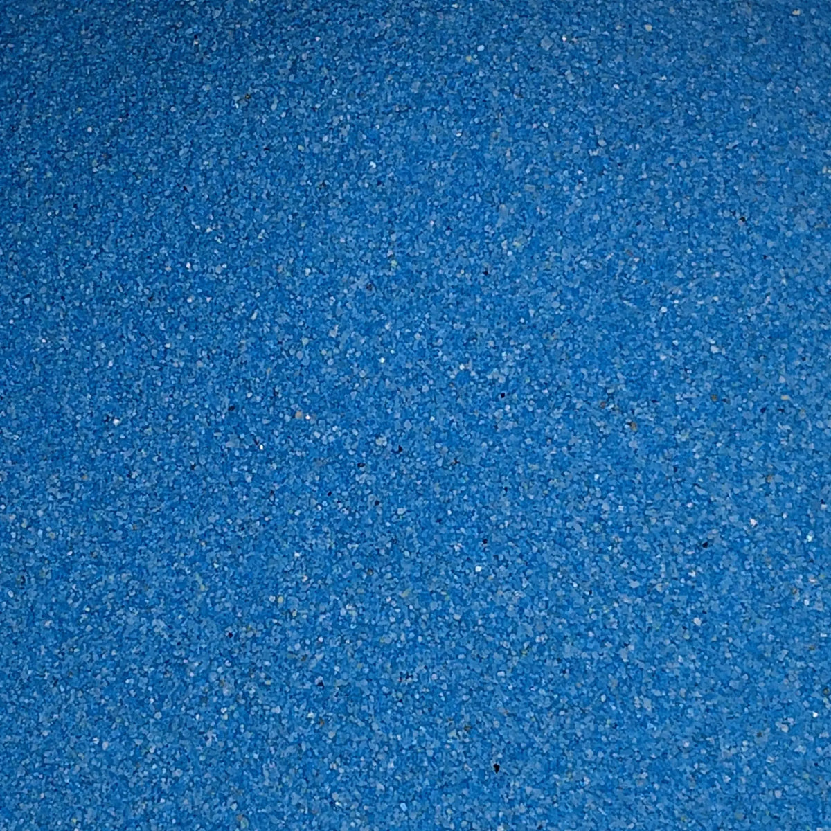 Close-up blue sand- for terrariums on a marble surface