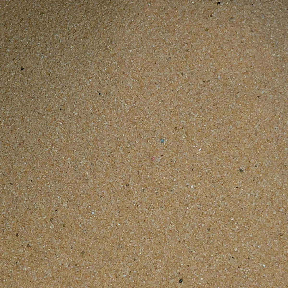 Close-up of brown sand on a light blue background