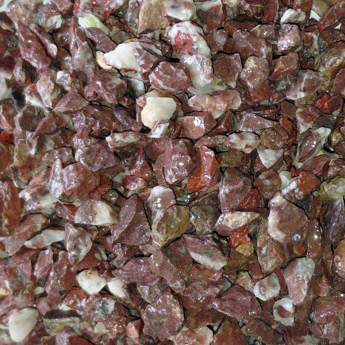Close-up of red and brown stones on a white background for terrariums